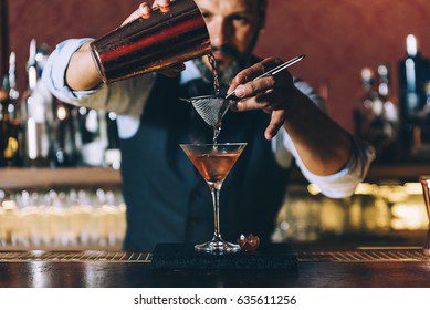 expert-barman-making-cocktail-night-260nw-635611256